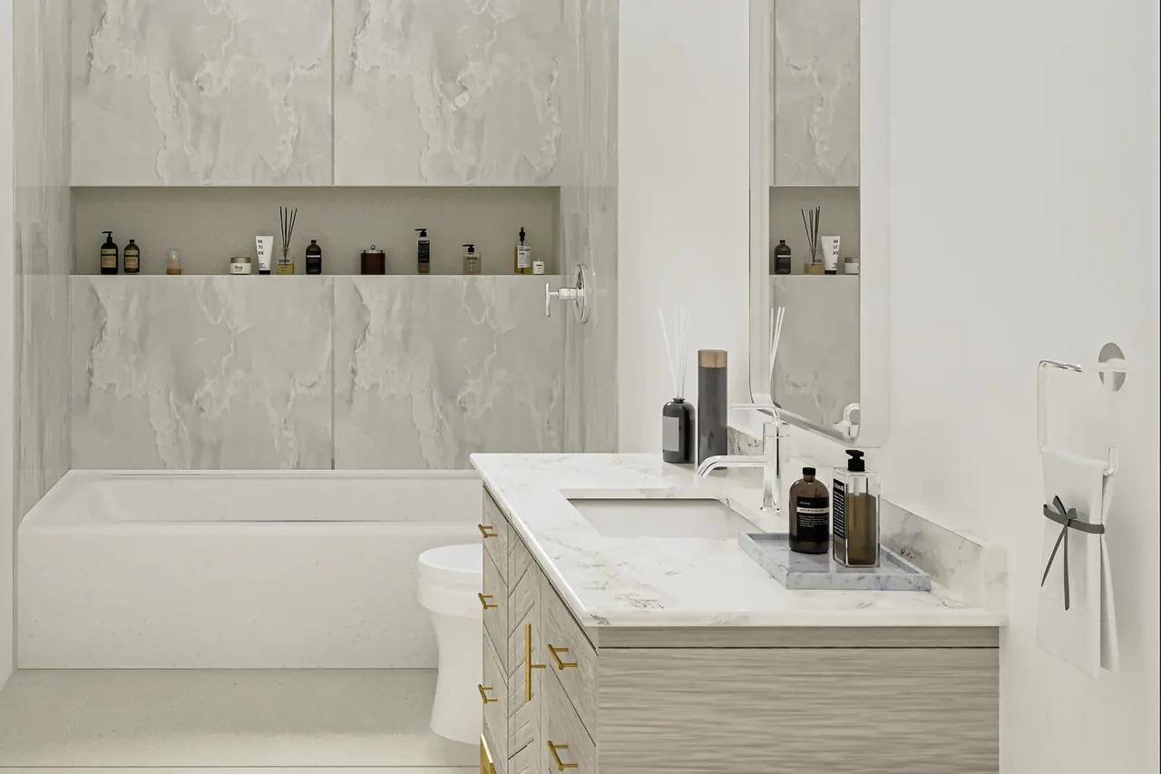Bathtub remodel design with a white tub and shower combo, groutless gray marble-look slab walls and a long niche