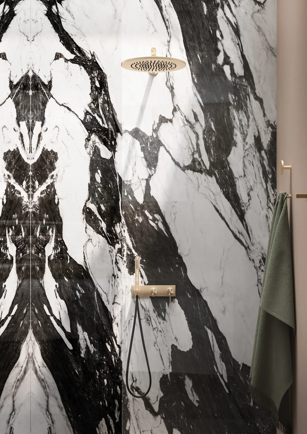 Shower wall in book-matched black and white marble slab with a brushed gold rain head and hand shower