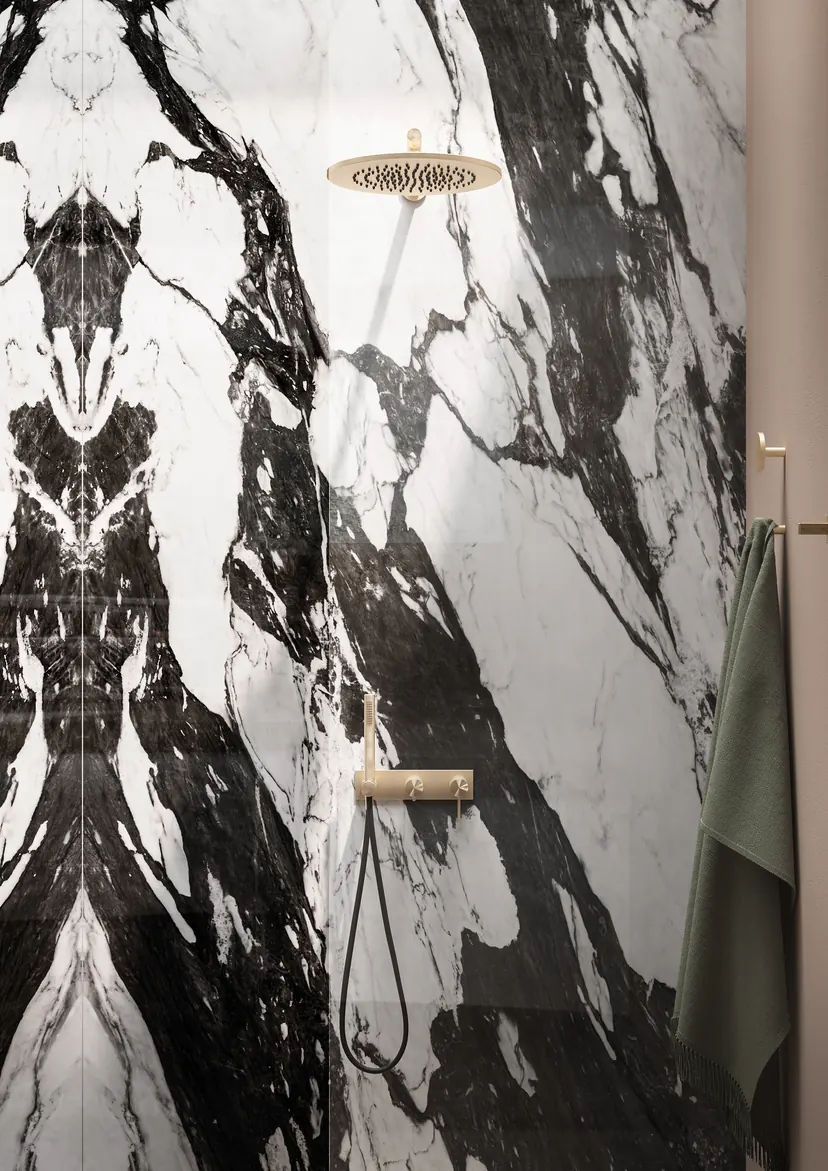 Fairview bathroom remodel idea: book-matched marble slab shower with a brushed gold rain head