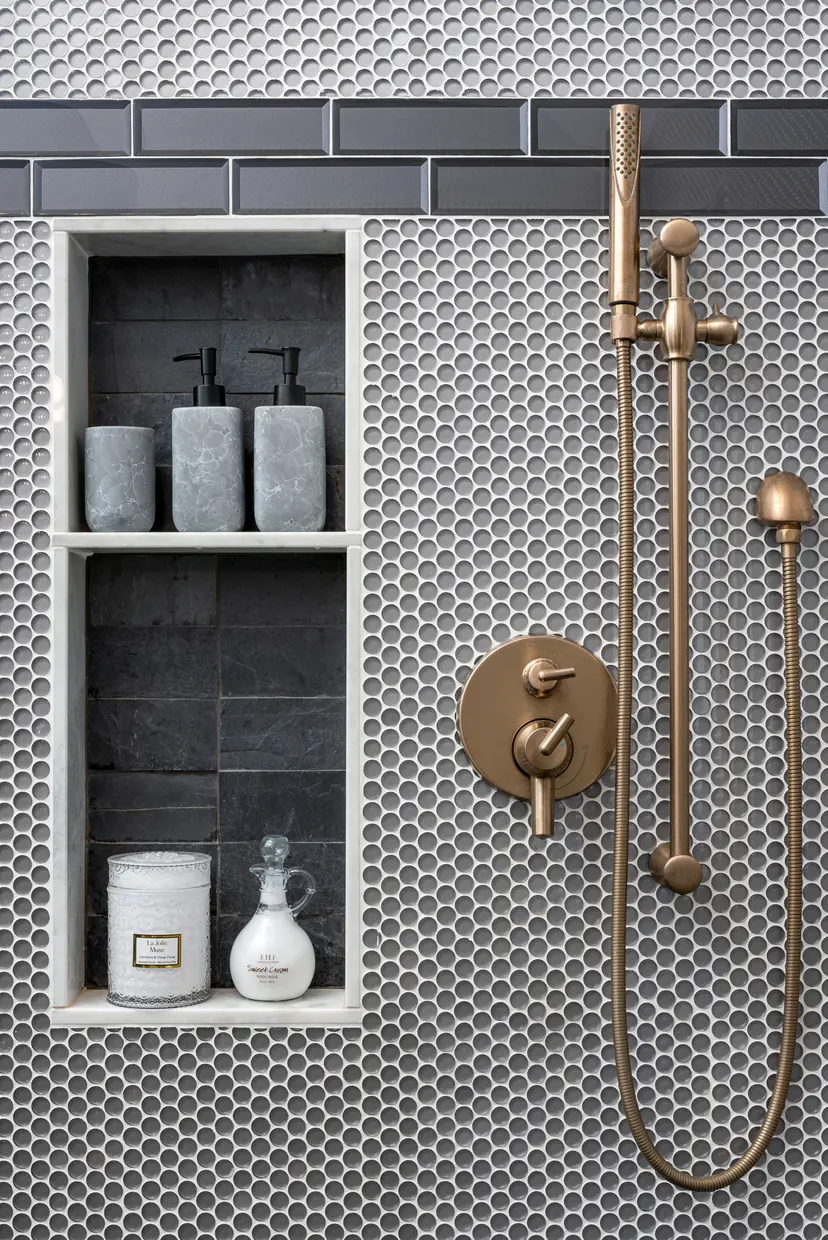 Fort Worth bathroom remodel idea: shower in gray penny tile with a niche and brushed brass fixtures
