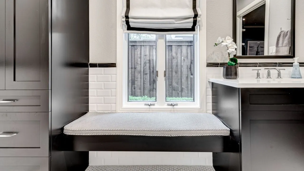 Grapevine bathroom remodel idea: guest bathroom with black cabinets, a window bench and subway tile