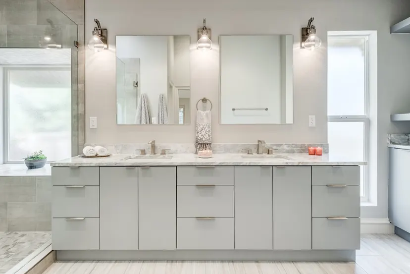 Lucas bathroom remodel idea: gray double vanity with marble counters, framed mirrors and sconces