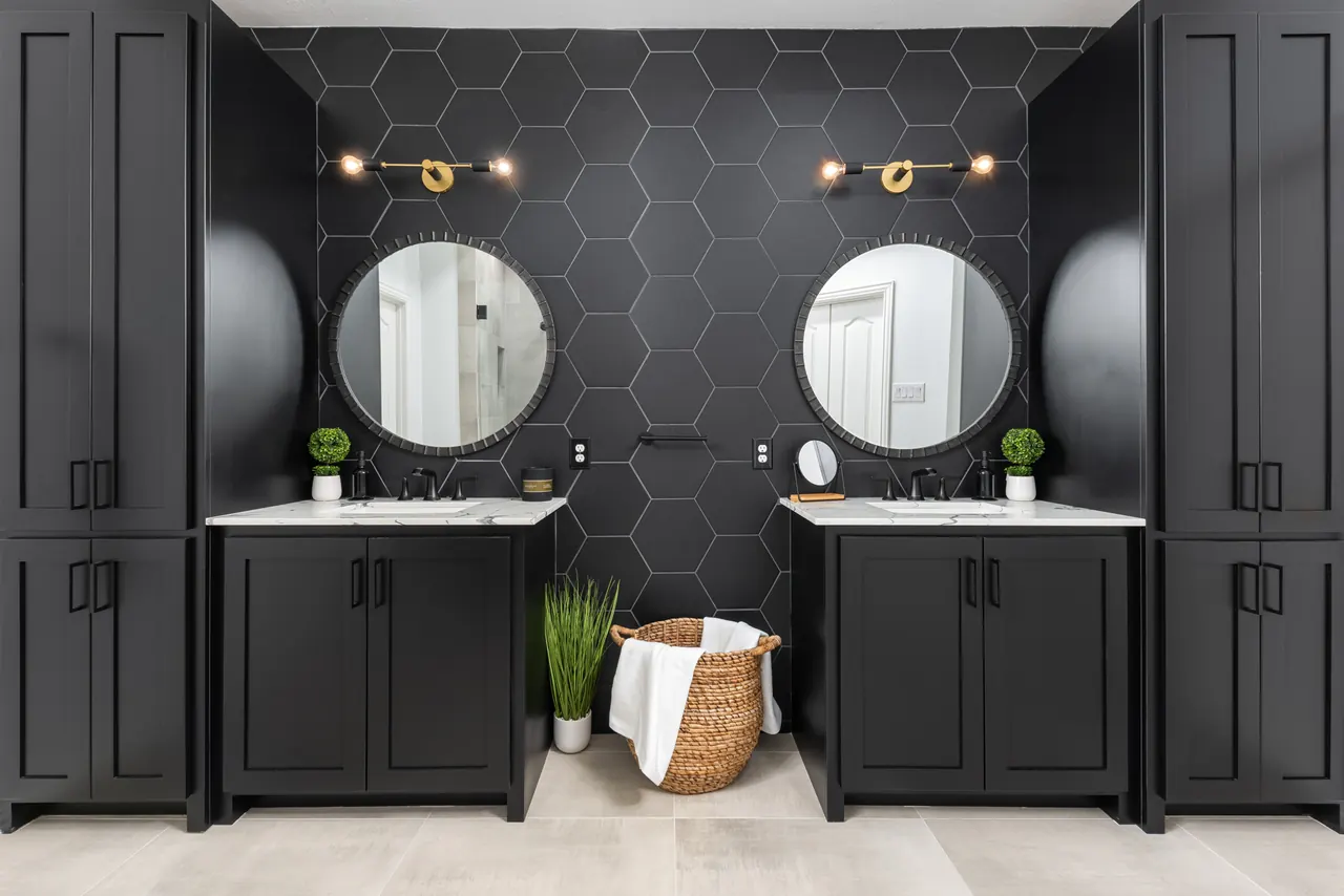 McKinney bathroom remodel idea: black double vanity, round mirrors and a black hexagon tile wall
