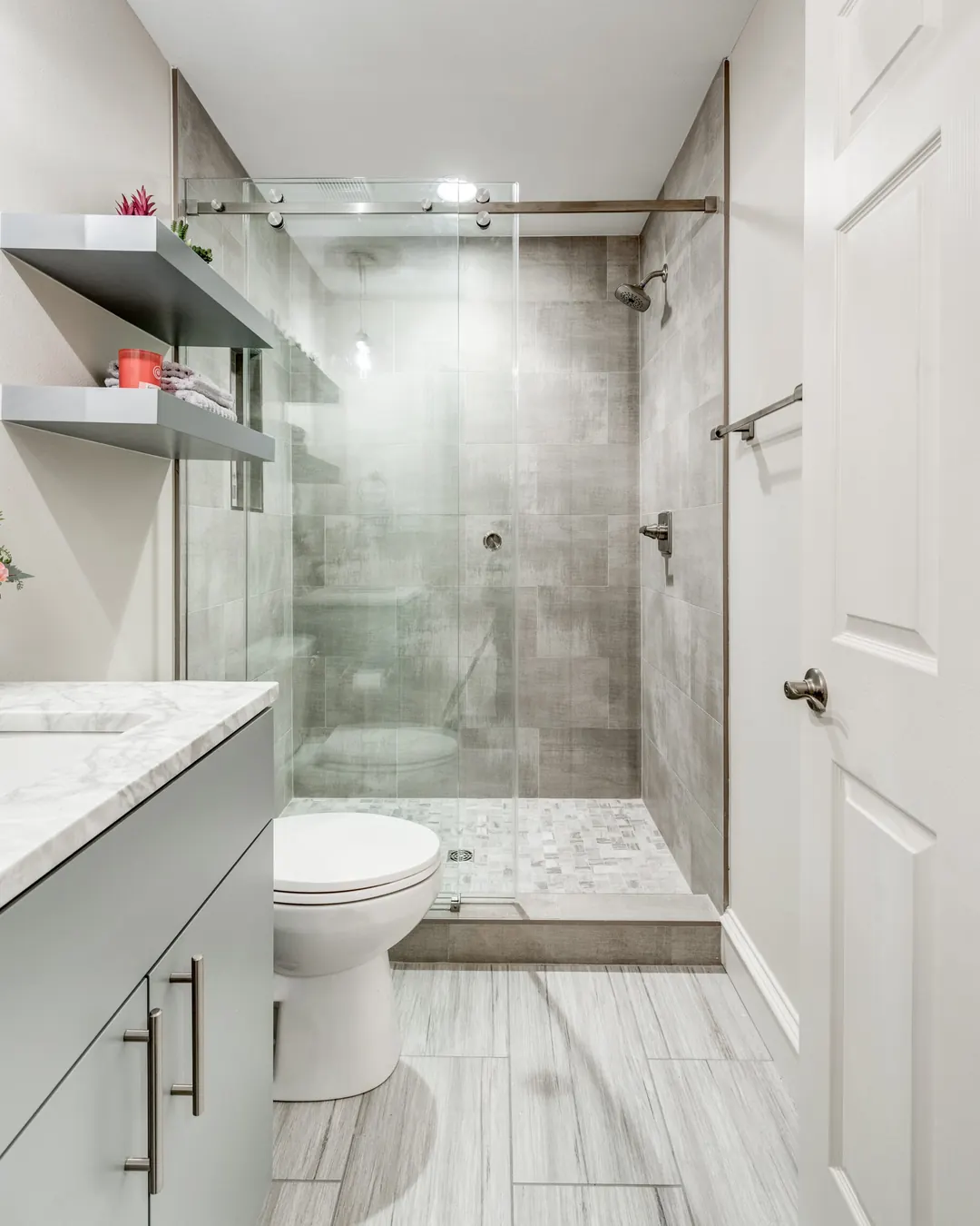Tub to shower conversion in Prosper by Nomi with a sliding glass door and gray tile walls